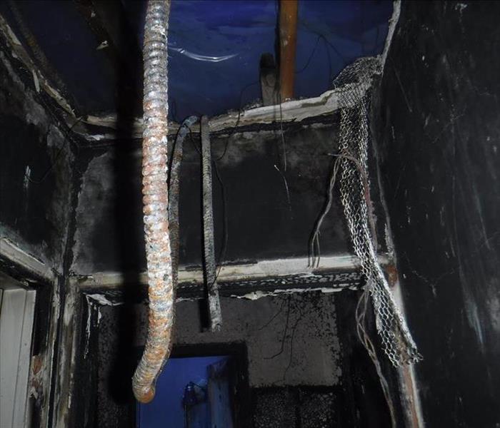 The interior of a house and cieling aftter a fire.