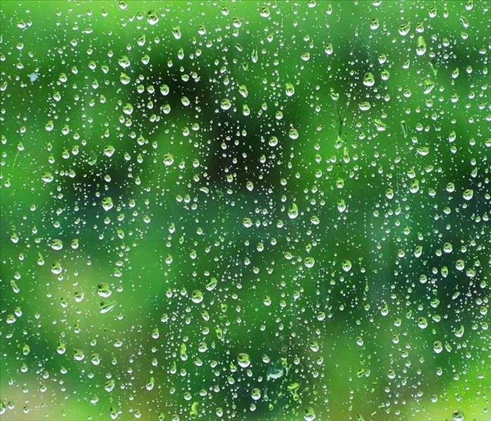 Raindrops on clear window glass.